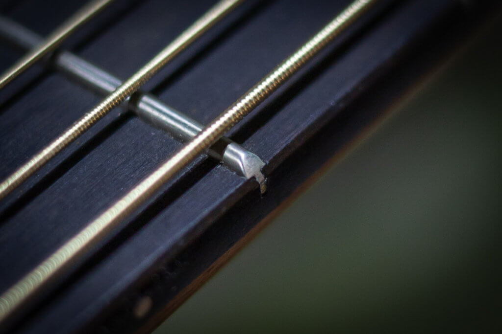 Shrinking frets on an acoustic guitar