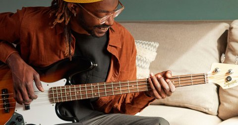 man playing the bass guitar